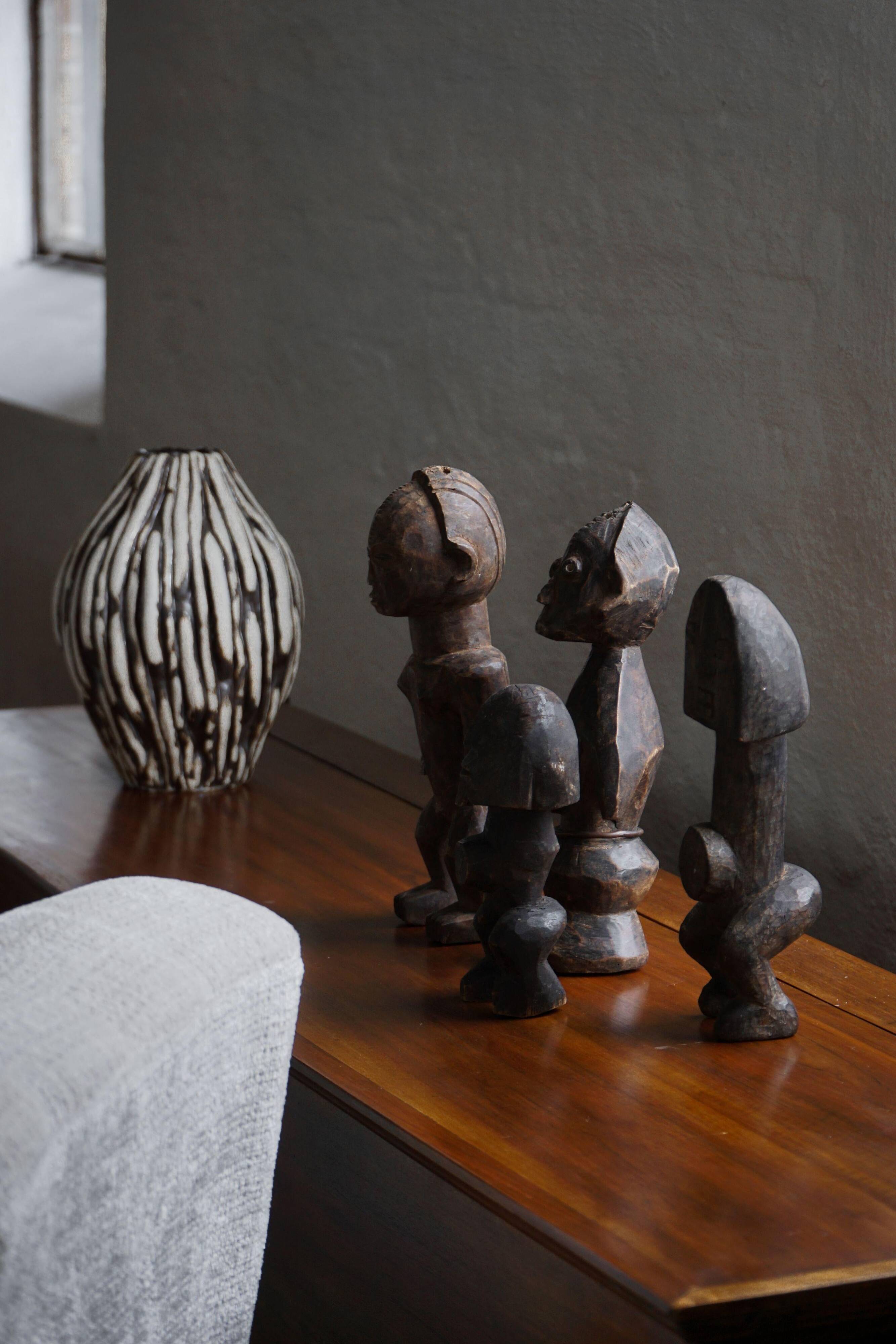 Set of 4 decorative handcrafted African wooden sculptures, mid-century.