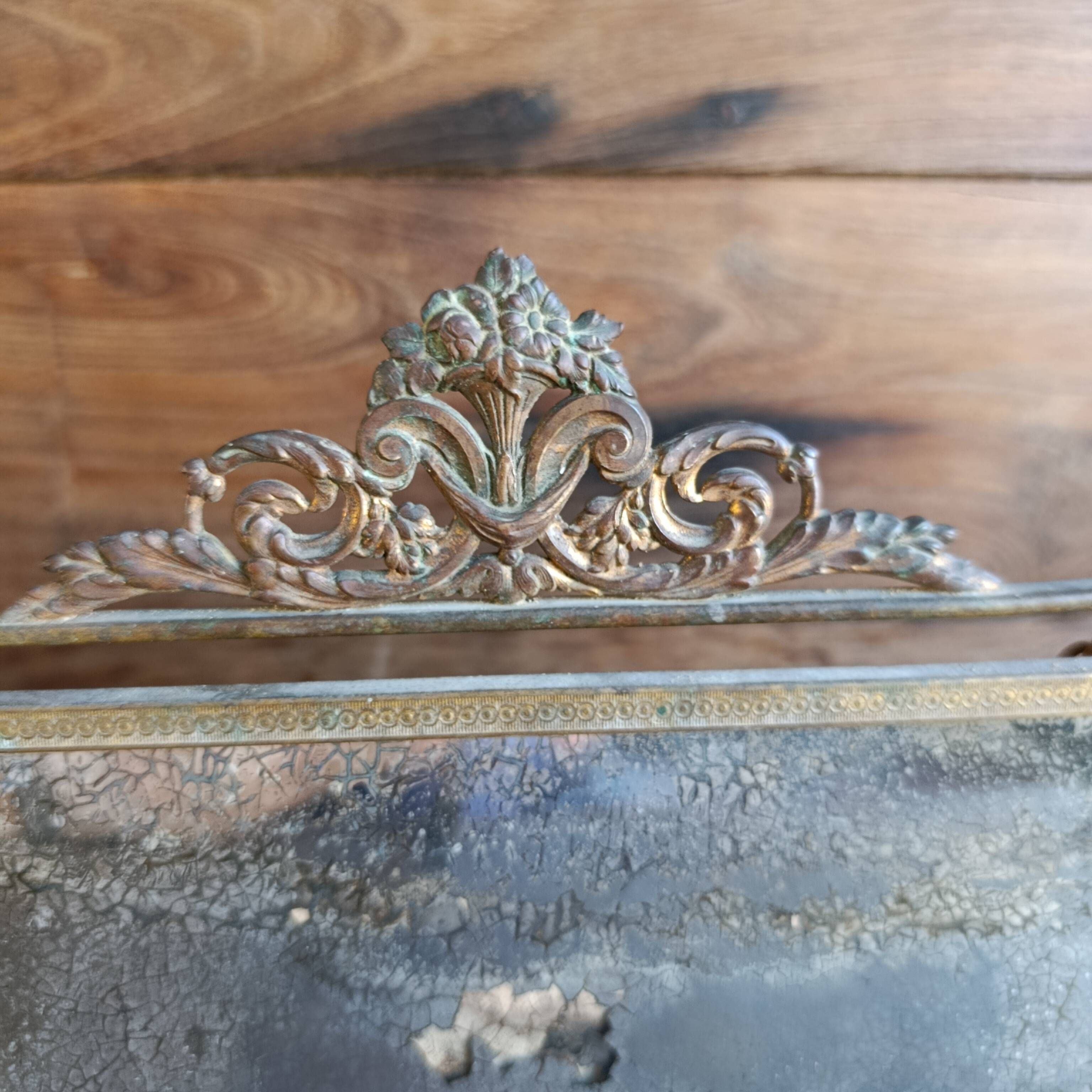Antique French gilt metal triptych vanity mirror with floral crest