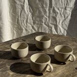Set of 4 vintage speckled beige stoneware coffee cups.