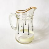 glass pitcher with black psyche patterns with gold edging from the 60s and 70s