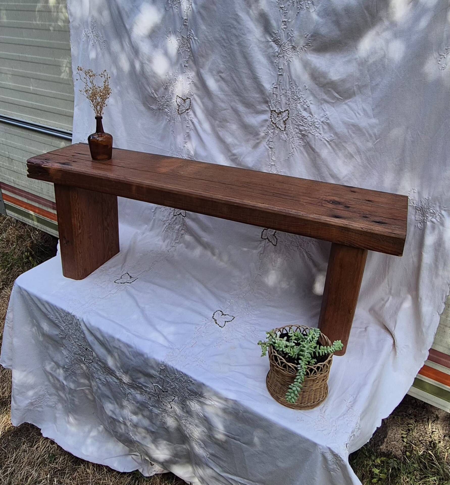 Brutalist wooden bench made of solid oak beam.