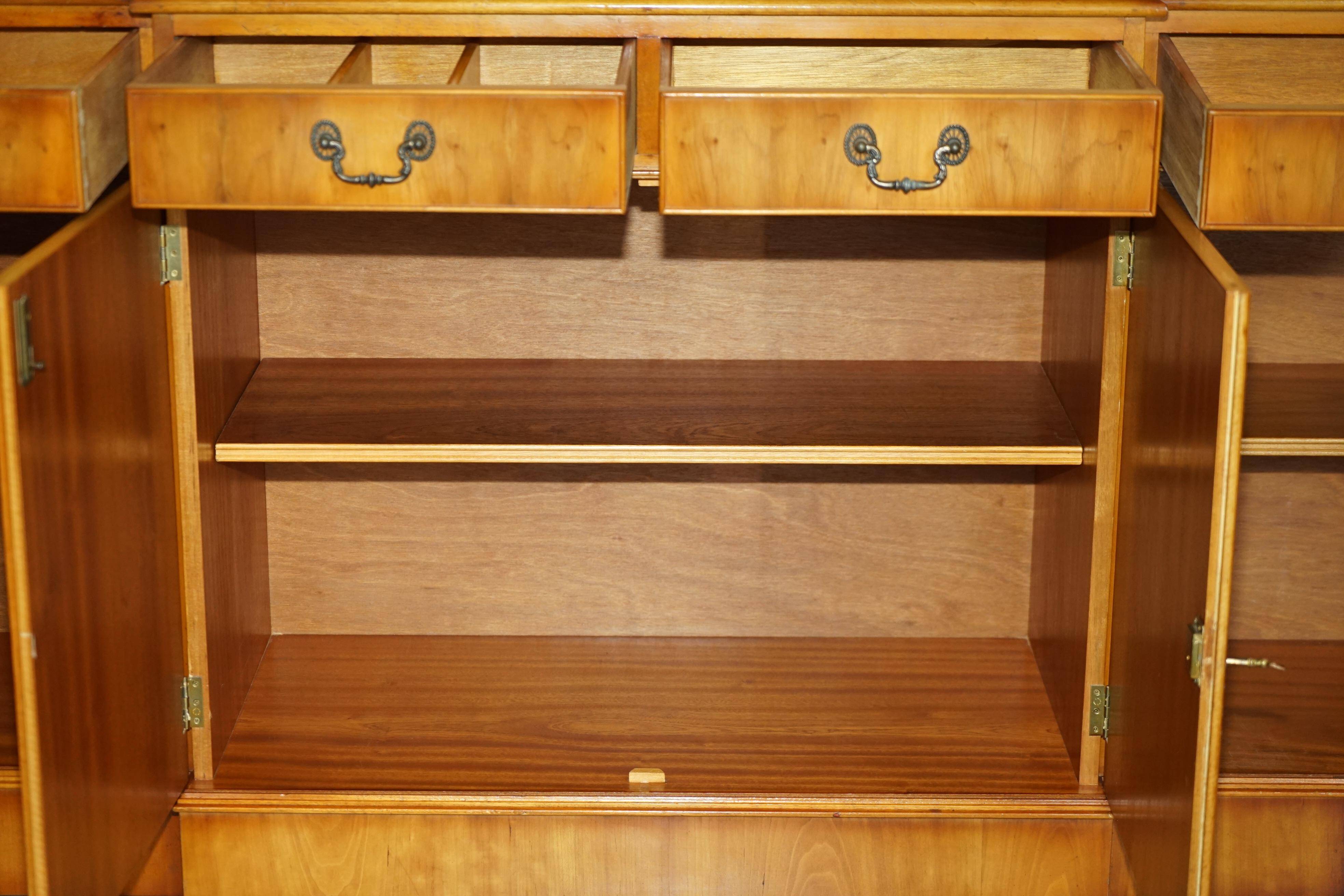 Vintage buffet made of mottled yew wood with three doors and four drawers.