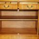 Vintage buffet made of mottled yew wood with three doors and four drawers.