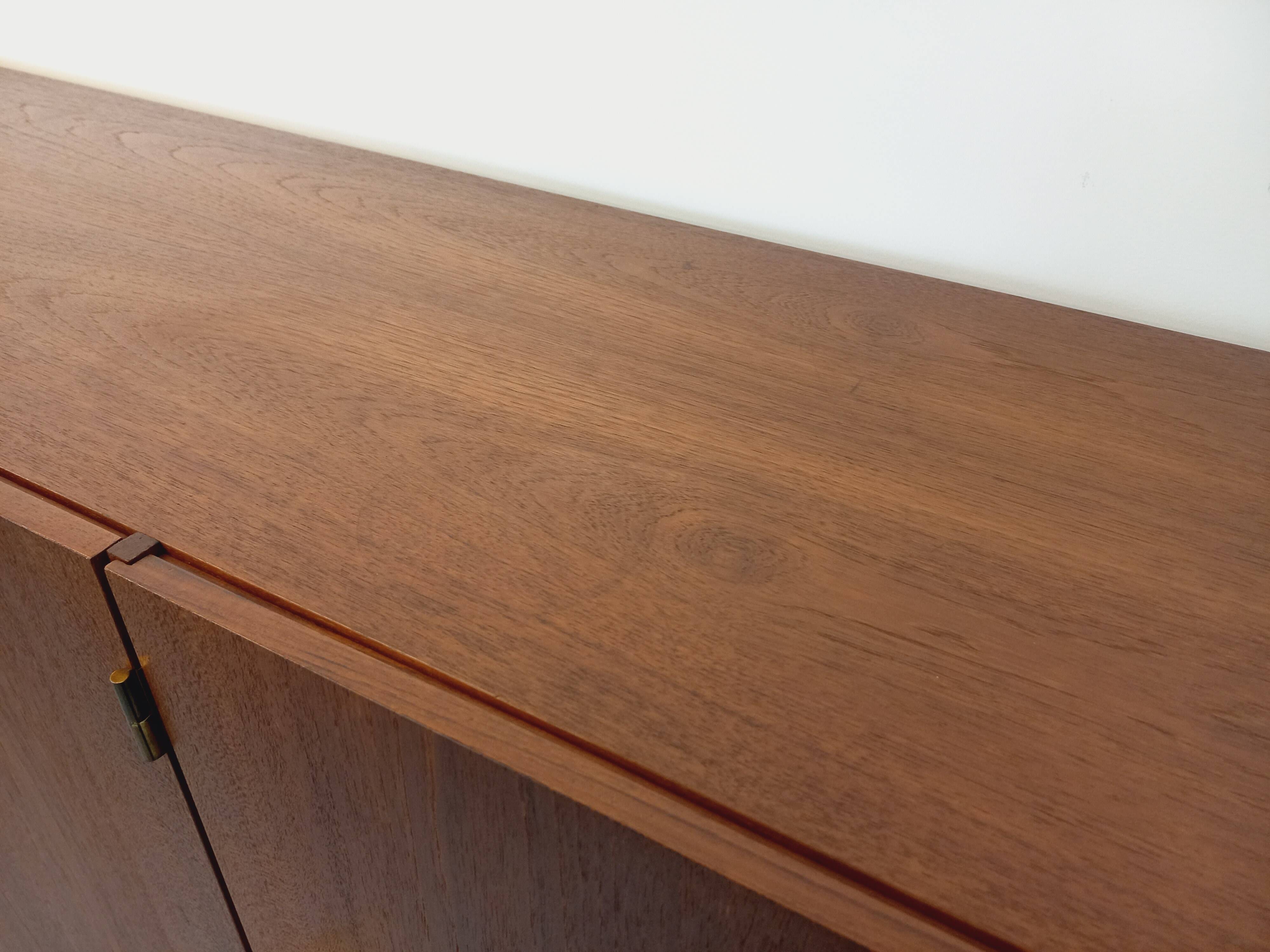 High Scandinavian modernist vintage sideboard in teak and black metal.
