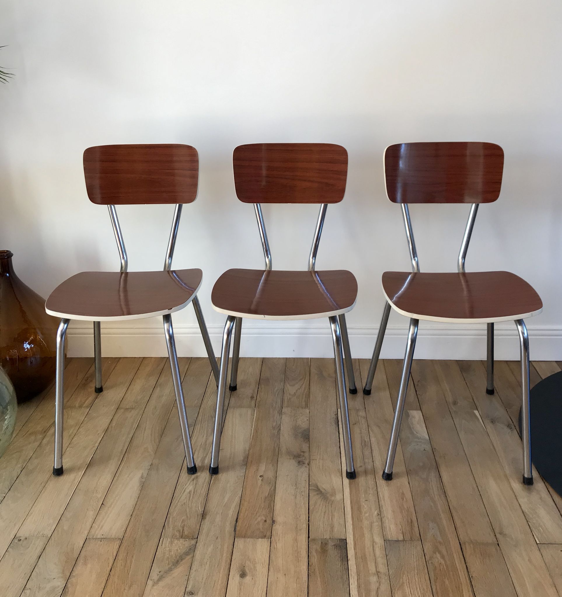 Trio of chairs in light brown formica and cream contour 70s