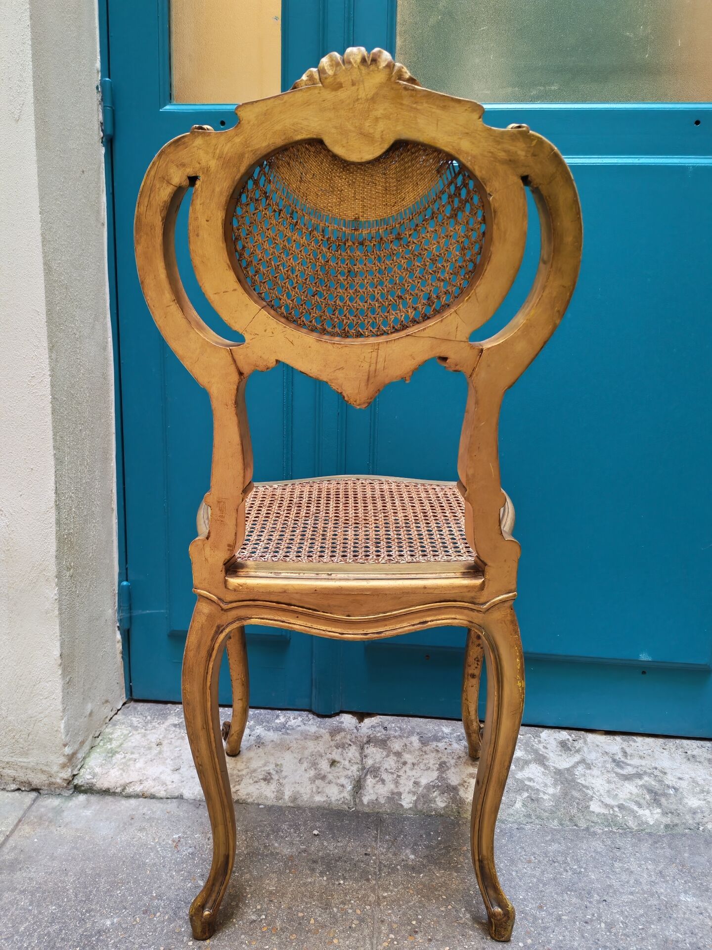 Antique rococo chair in gilded wood and caning