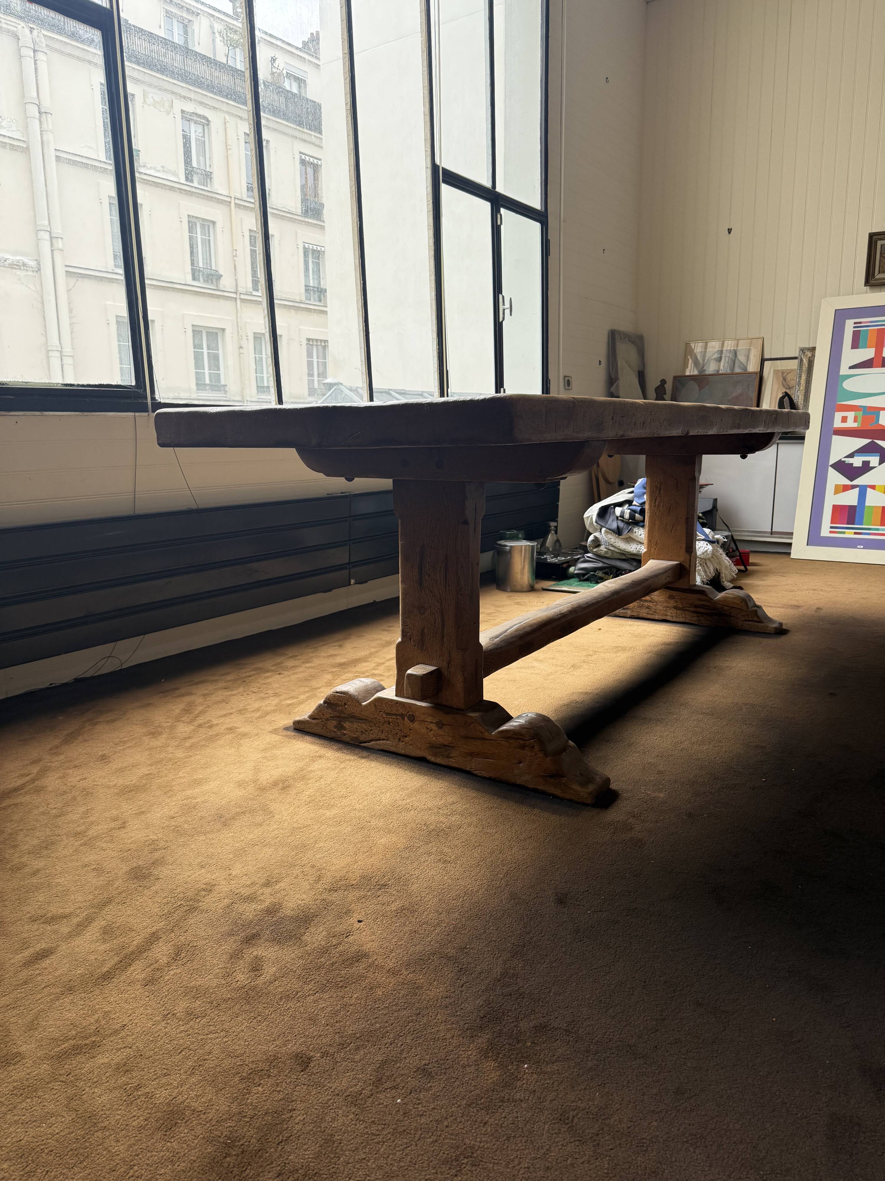 Large antique farmhouse table made of solid wood, in monastery style.
