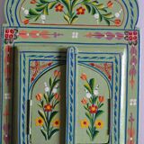 Mirror under shutters with painted flower decoration