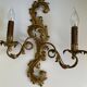 Pair of Italian Hollywood Regency wall lights in iron and gilded sheet metal.