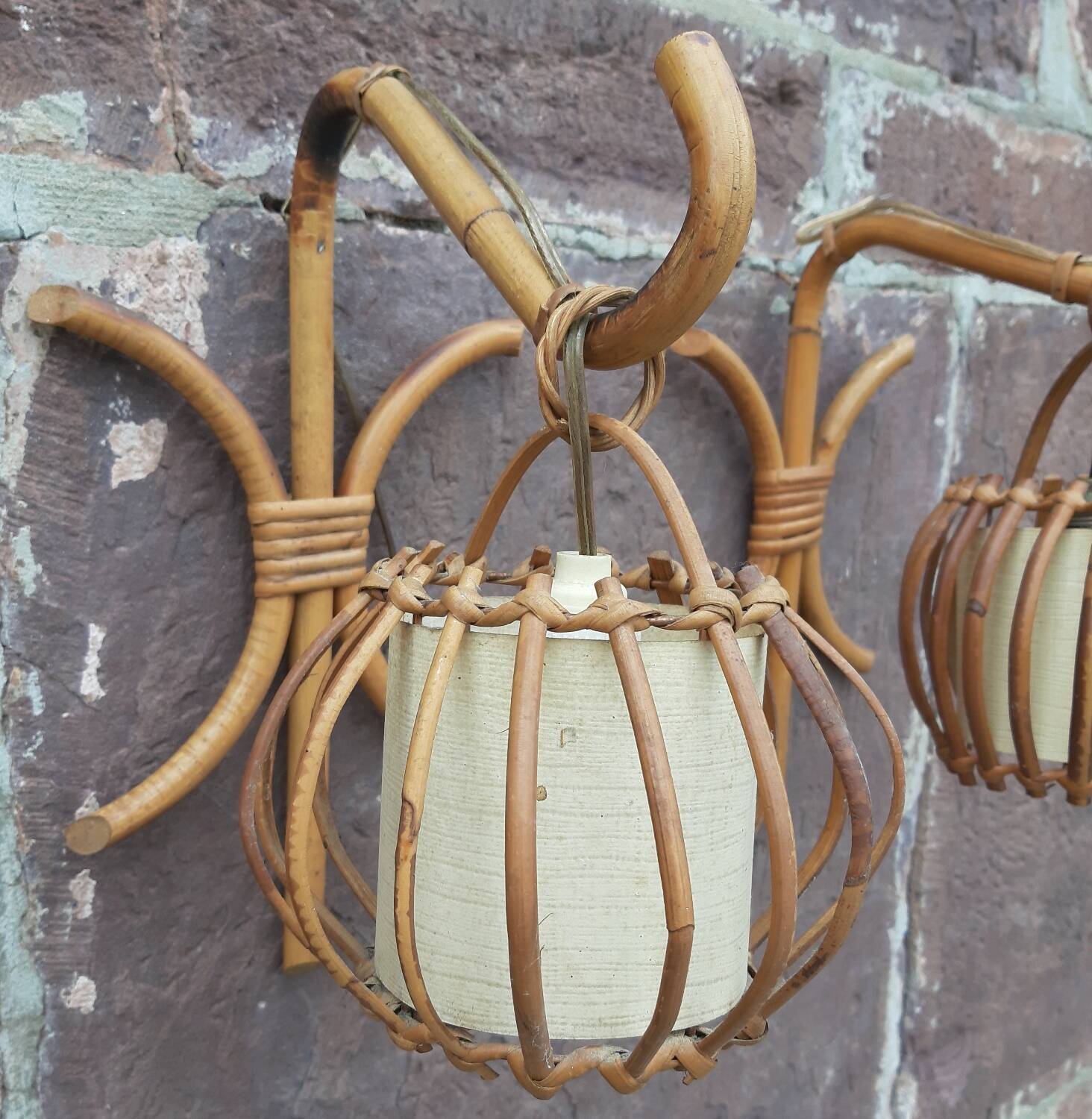 Pair of Louis Sognot rattan wall lights.