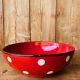 Ceramic salad bowl in red with white polka dots.