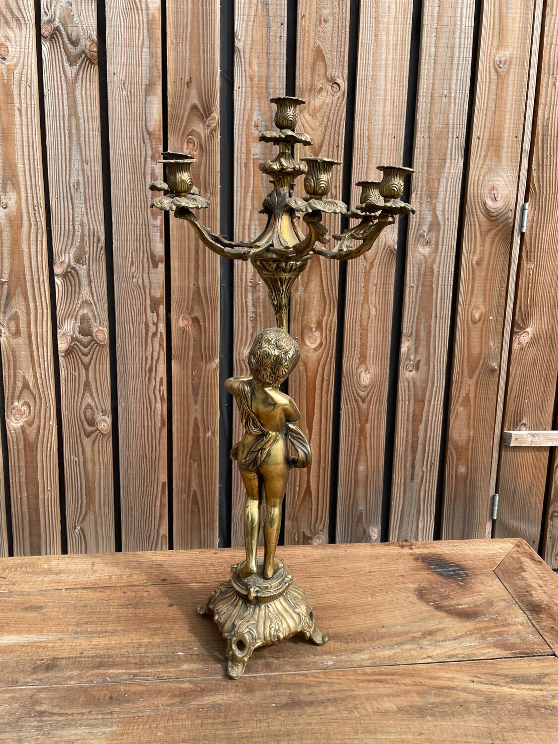 Large bronze candle holder with putti angel