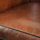Sheepskin club armchair with deep warm colours and black piping