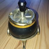 Original vintage ashtray on a small wheeled stand.