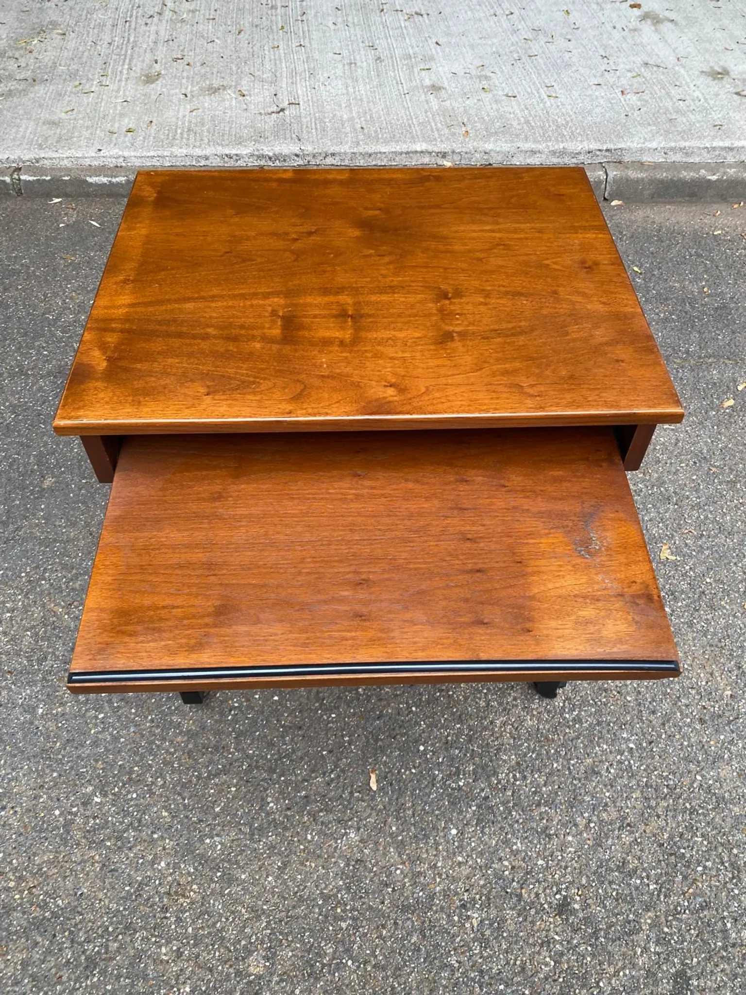Small Scandinavian-style computer desk on wheels made of wood.