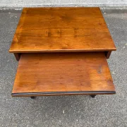 Small Scandinavian-style computer desk on wheels made of wood.