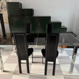 Vintage Roche Bobois dining table with smoked glass and 4 leather chairs.