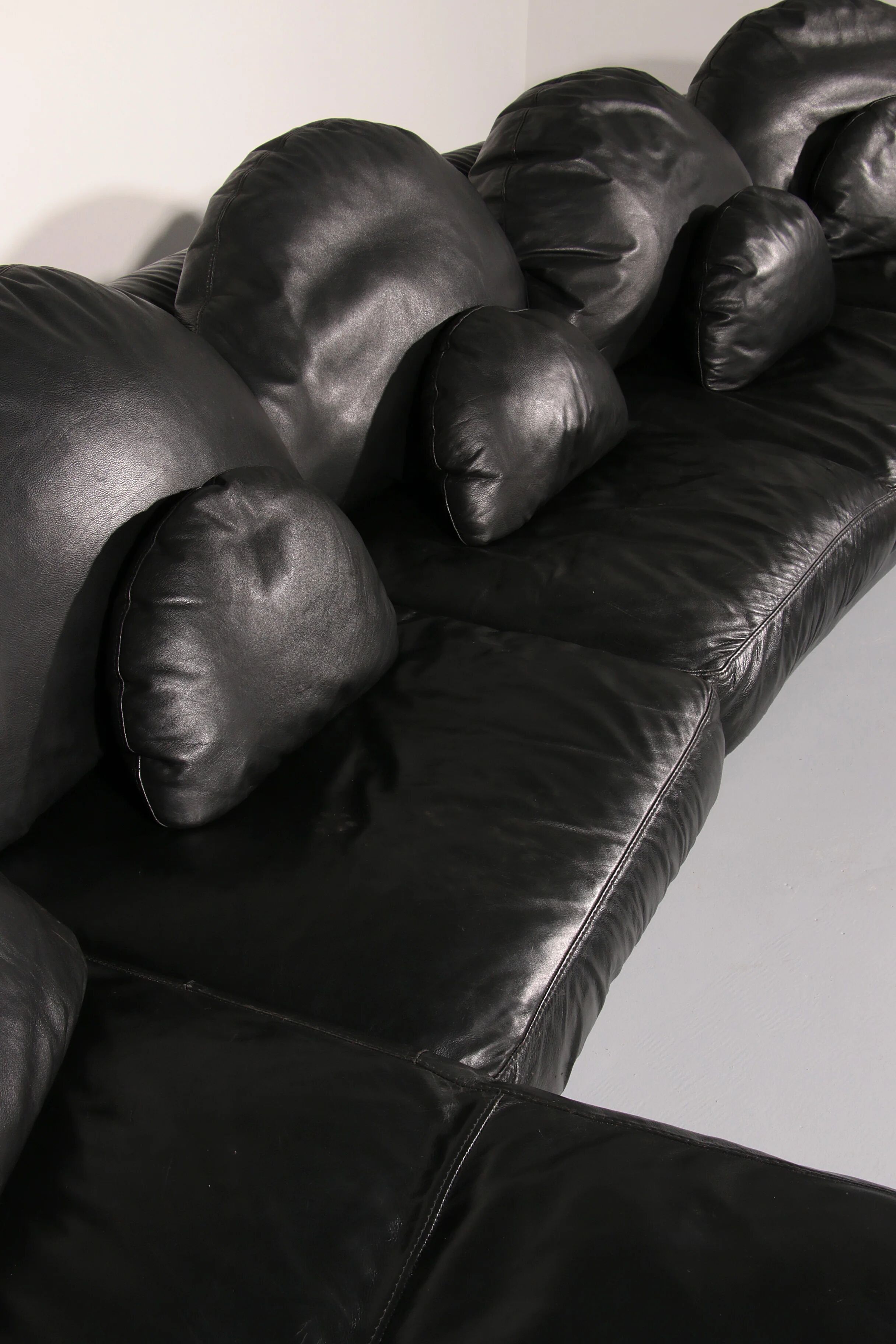 Organically shaped post-modern sectional sofa in black leather
