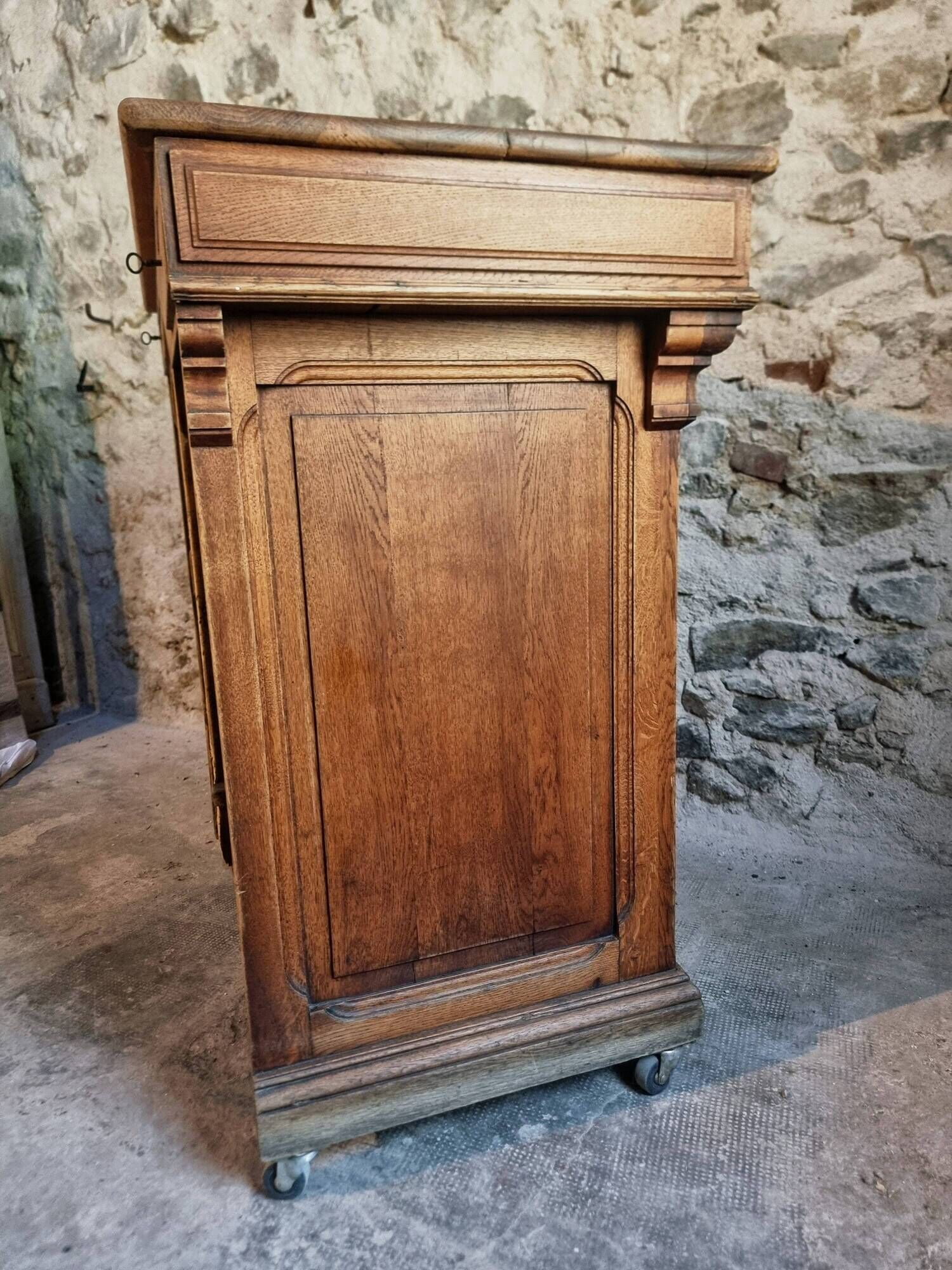 Antique French oak shop counter, kitchen island on wheels, circa 1880–1900.