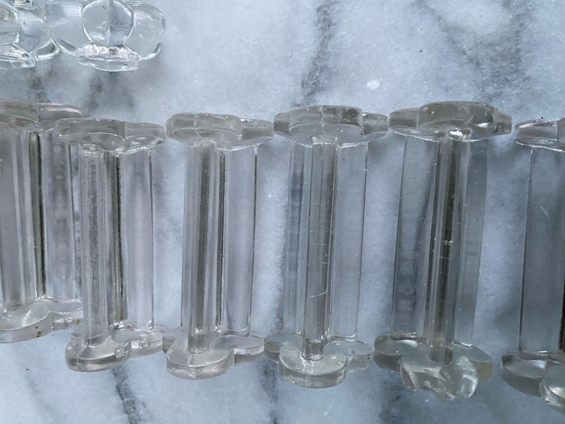 Set of 12 vintage glass knife rests in clear moulded glass.