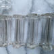 Set of 12 vintage glass knife rests in clear moulded glass.
