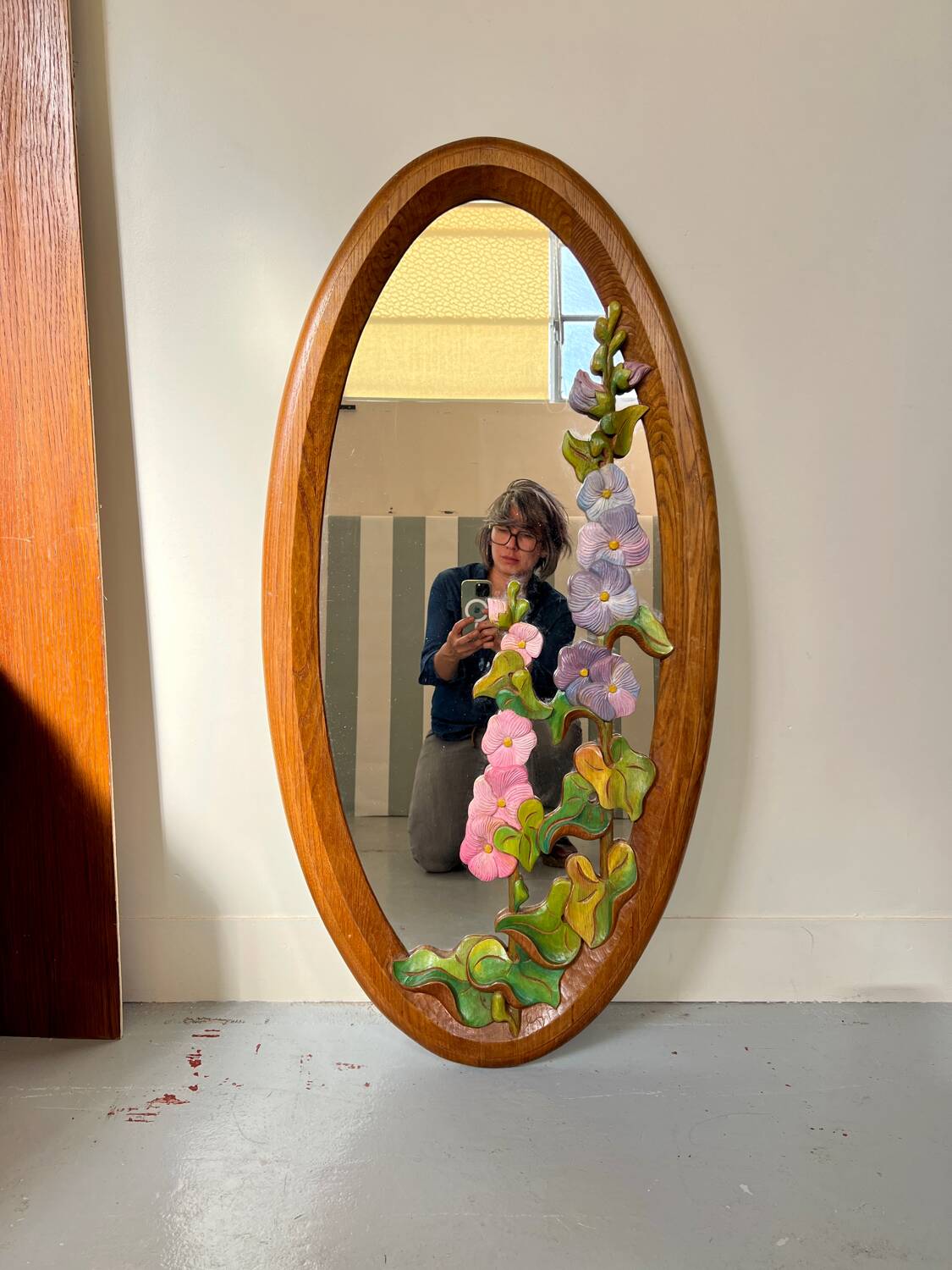 Carved wooden mirror with flower decorations