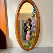 Carved wooden mirror with flower decorations.