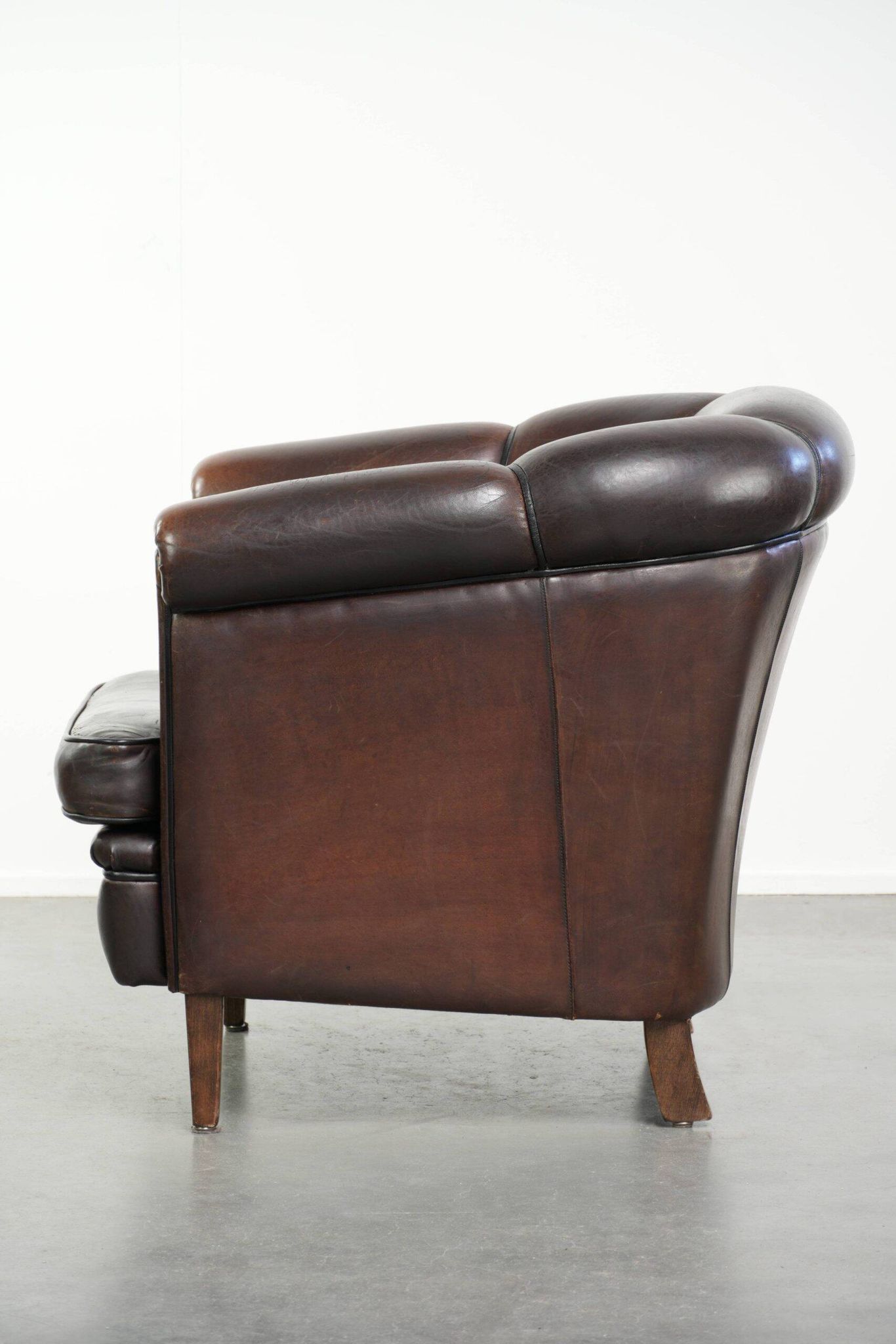 Dark sheepskin club armchair with unique design in English style