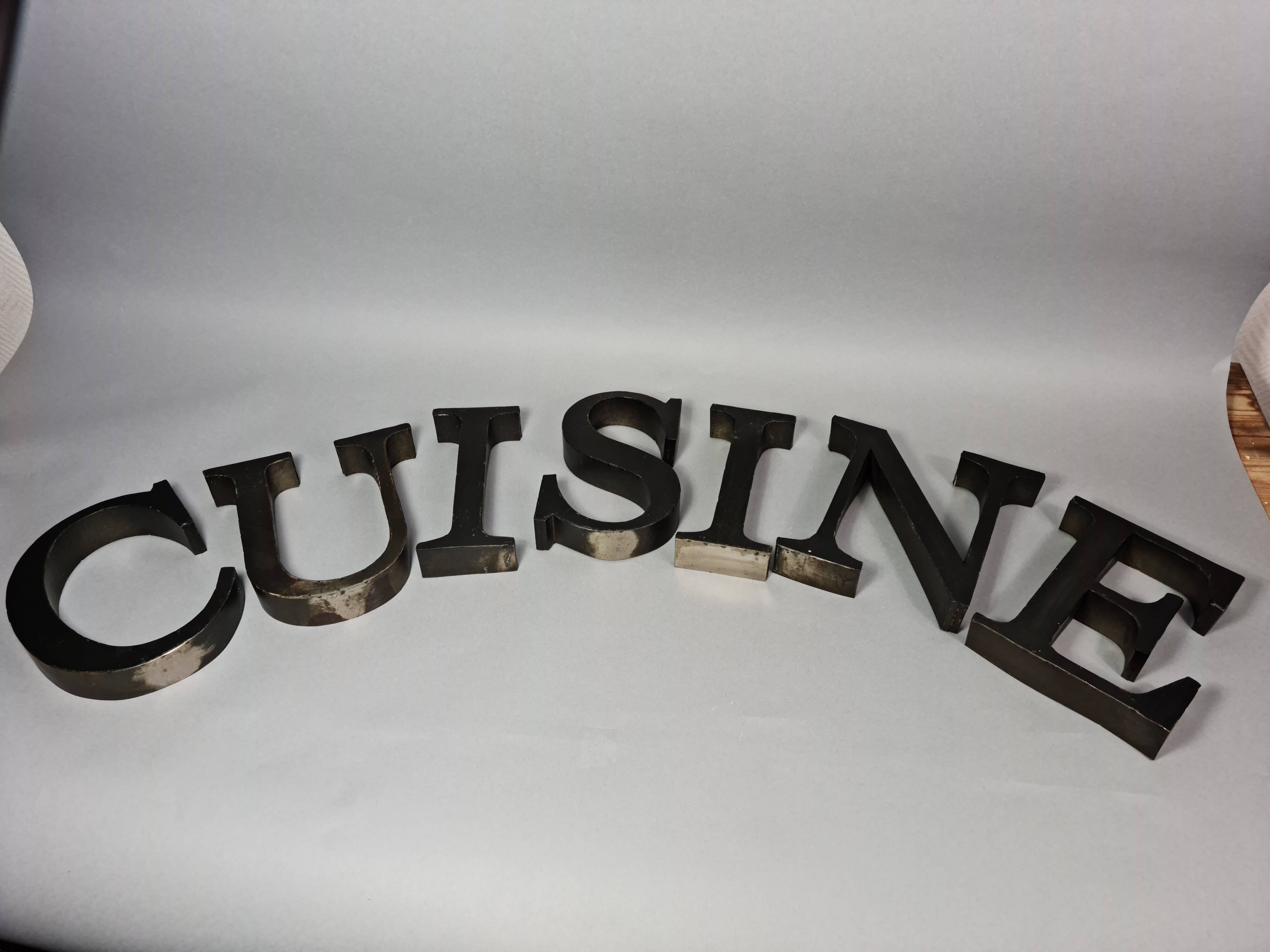 "kitchen" lettering set in blackened metal