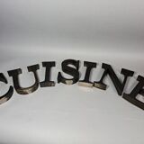 "kitchen" lettering set in blackened metal