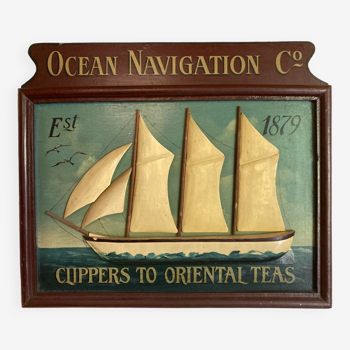 Painted wooden table boat carved in relief: Ocean Navigation Co