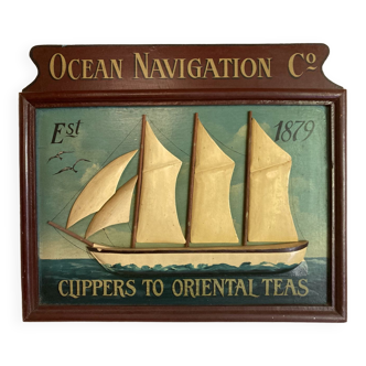 Painted wooden table boat carved in relief: Ocean Navigation Co