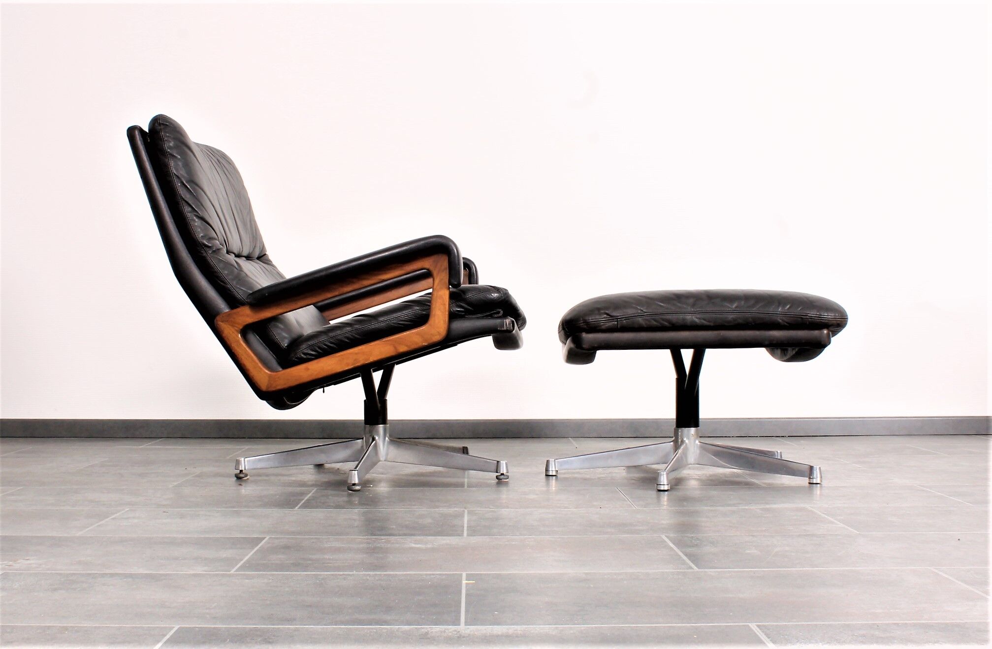 Armchair and footstool by André Vandenbeuck for Strässle in black leather