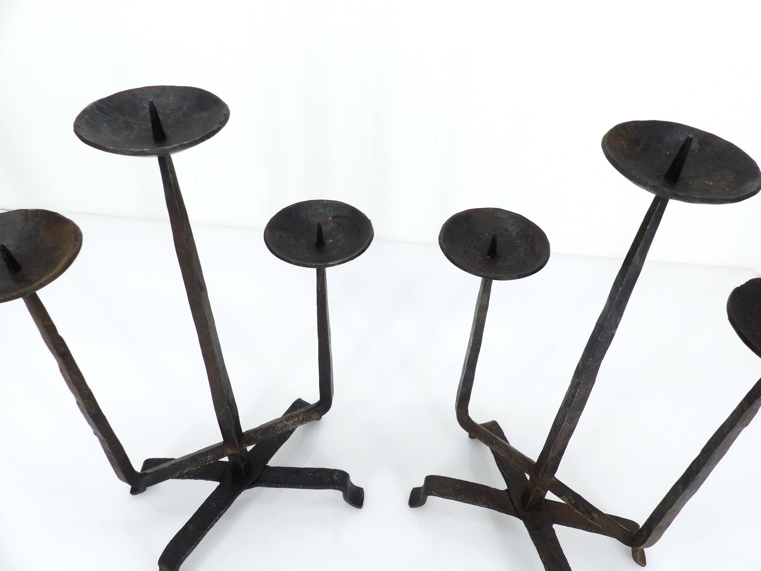 Pair of brutalist wrought iron candlesticks, France, three lights, signed