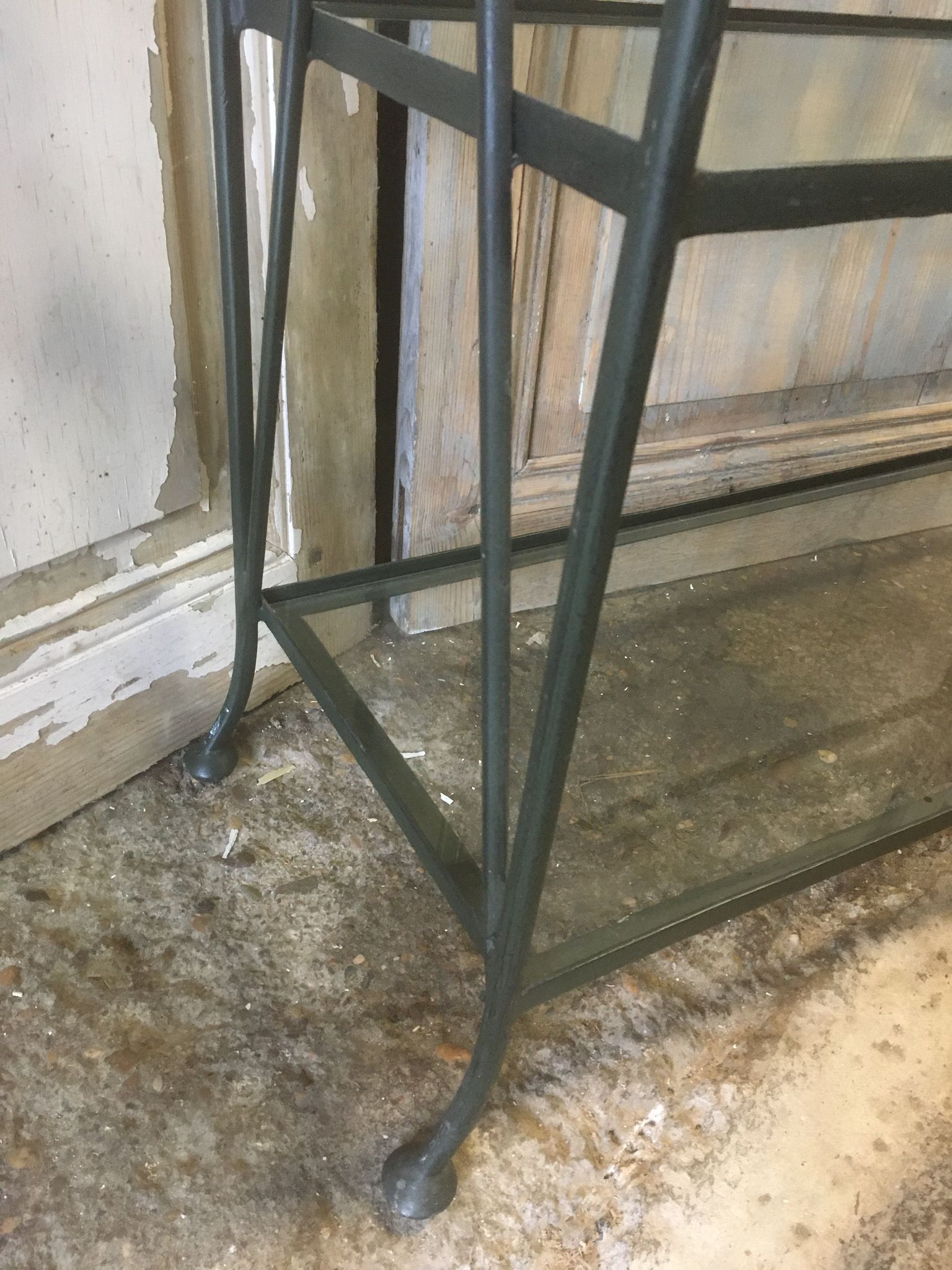 Pair of wrought iron and glass bookshelf shelves.