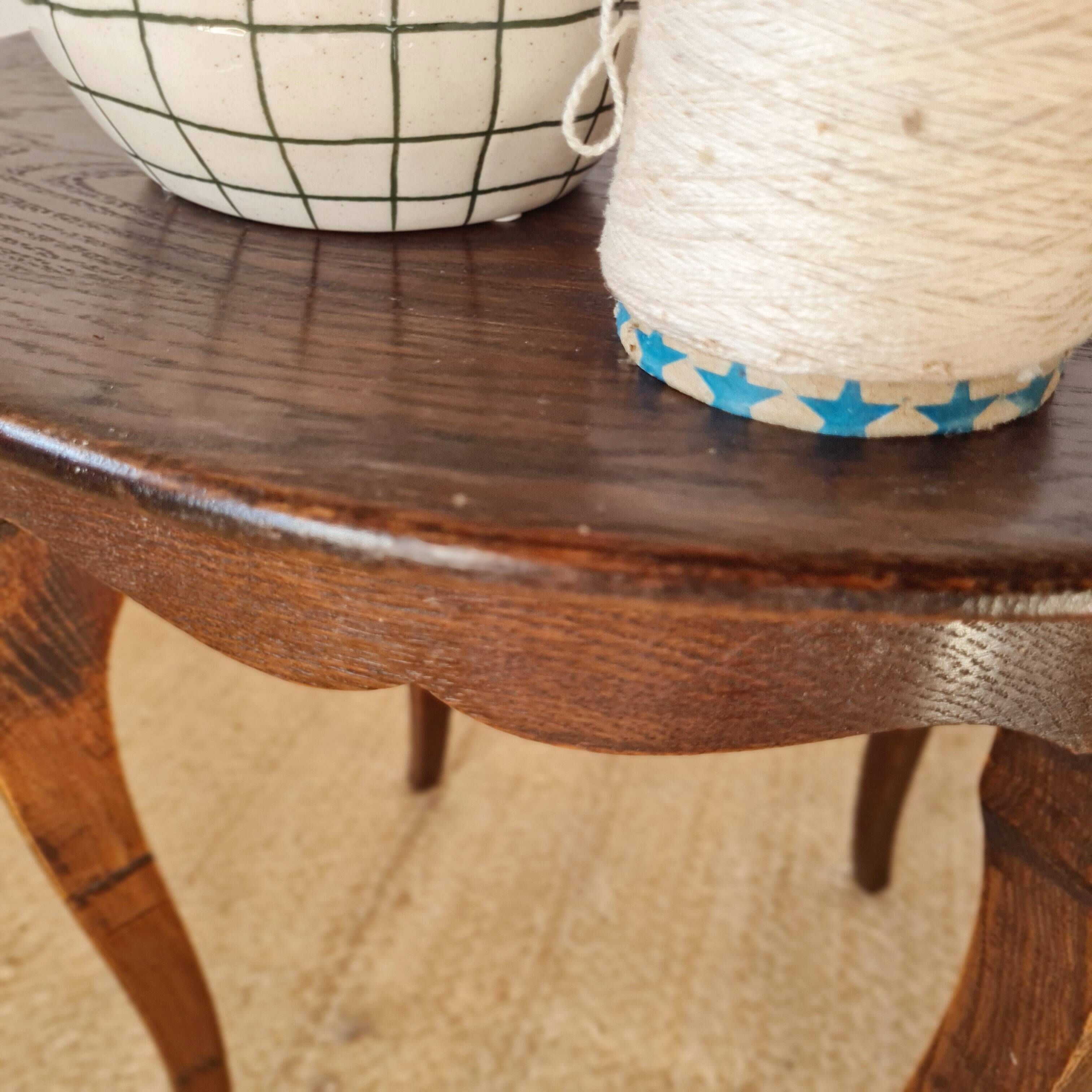 Vintage solid wood side table with curved legs.