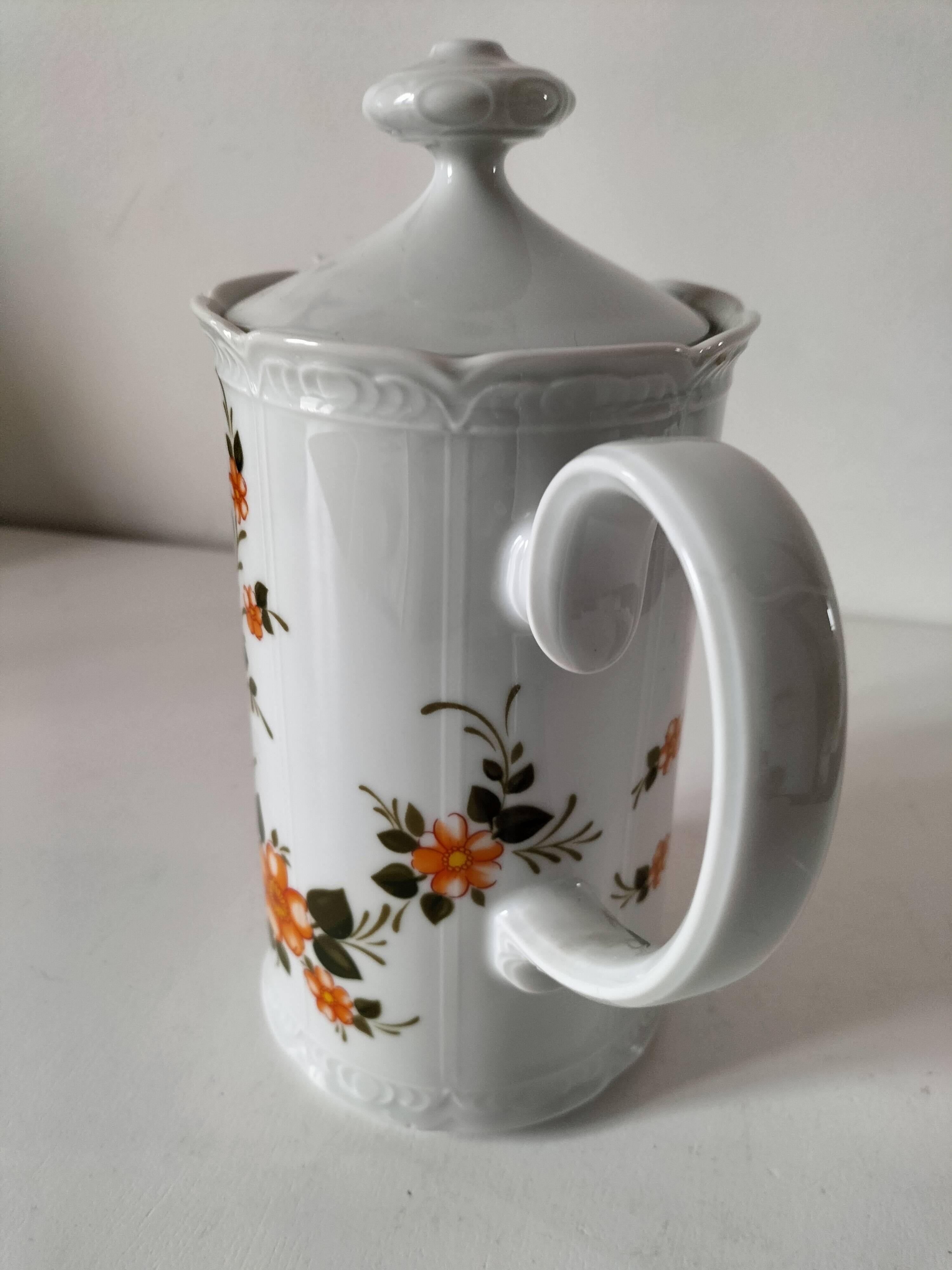 Vintage coffee pot Winterling Bavaria with orange floral decoration.