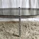 Table basse de forme élyptique en metal chomé et verre fumé, années 70