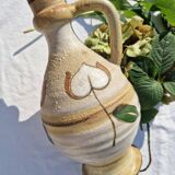 Handcrafted jug or jar with a handle, terracotta pottery vase, fat lava effect, stylized flowers