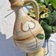 Handcrafted jug or jar with a handle, terracotta pottery vase, fat lava effect, stylized flowers