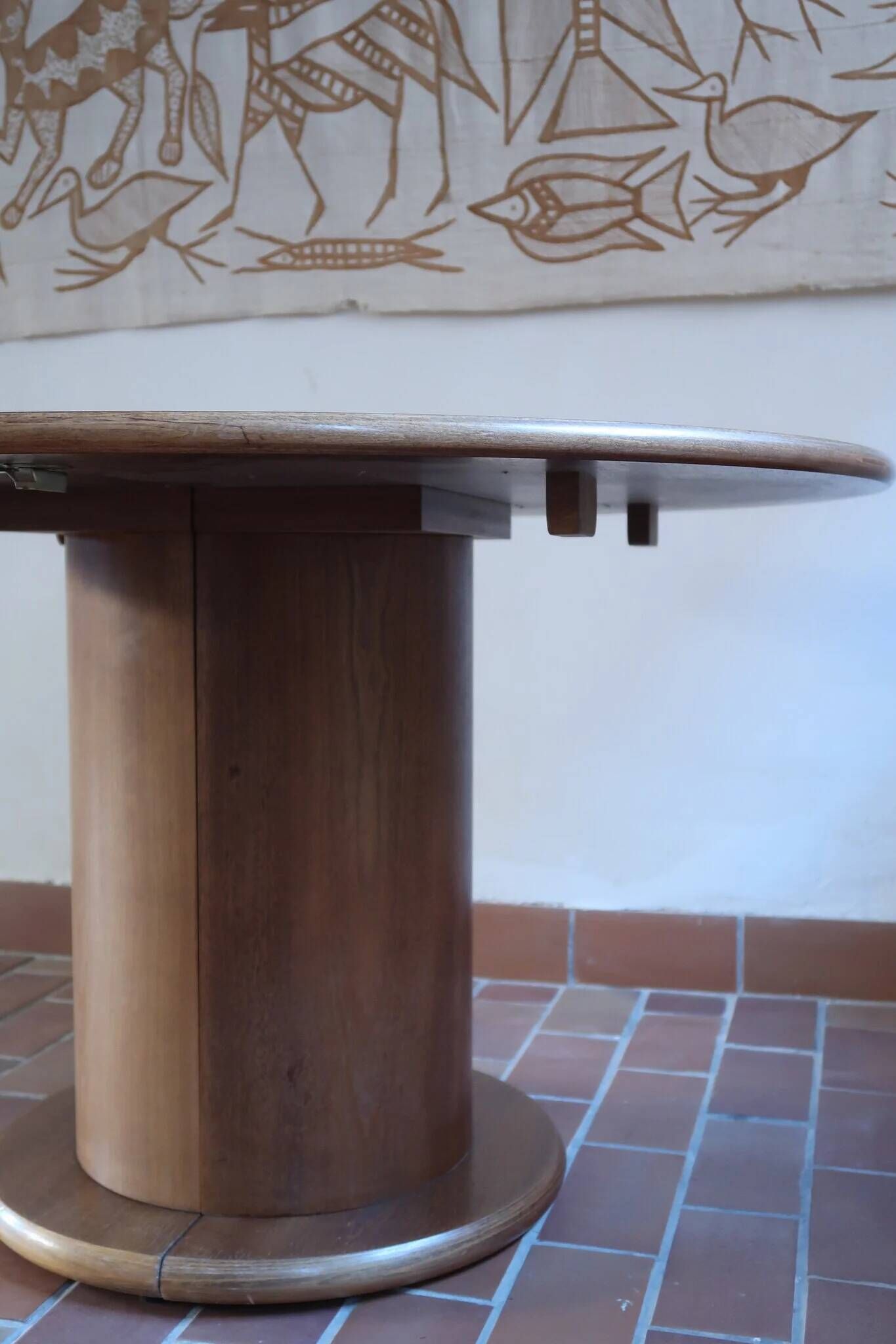 Round table with a central pedestal, light wood, 1990s.