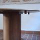 Round table with a central pedestal, light wood, 1990s.