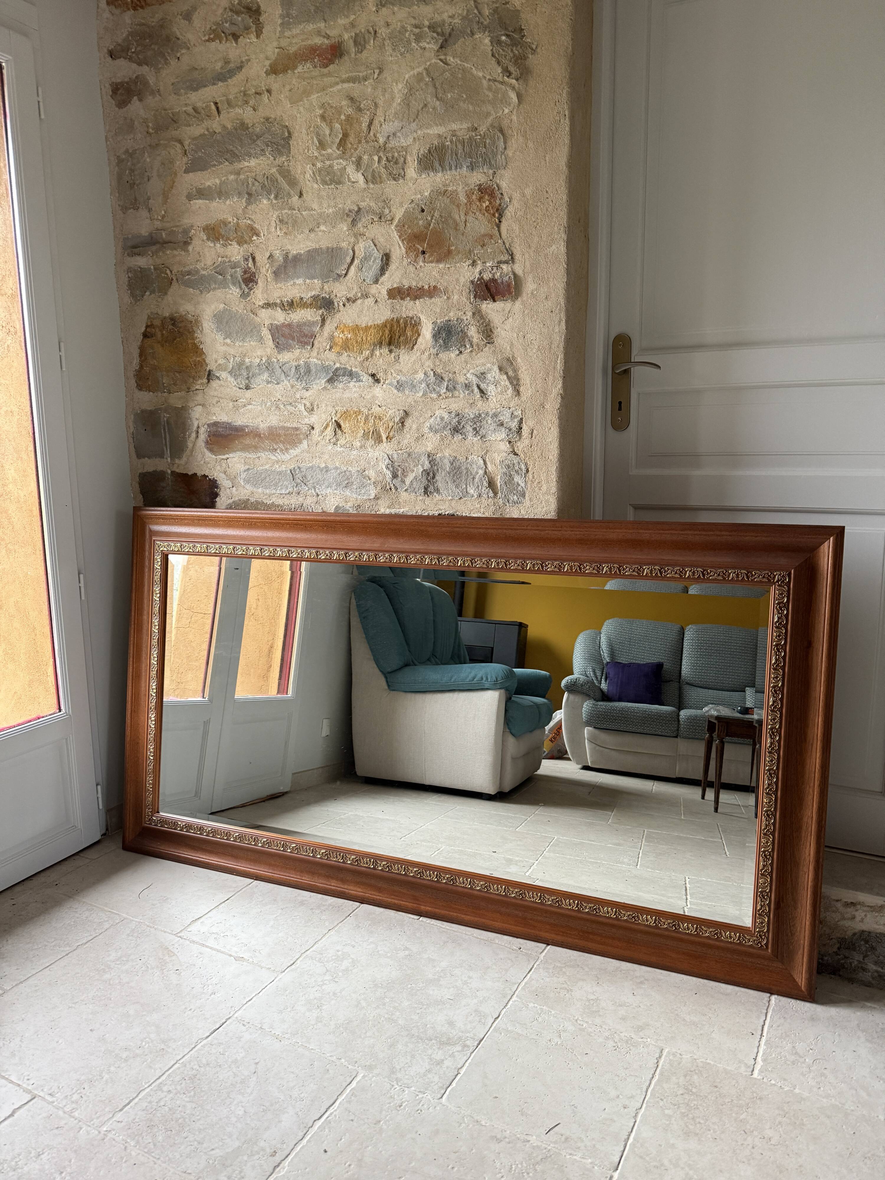 Large bevelled tabletop mirror in carved gilded wood.