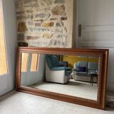 Large bevelled tabletop mirror in carved gilded wood.