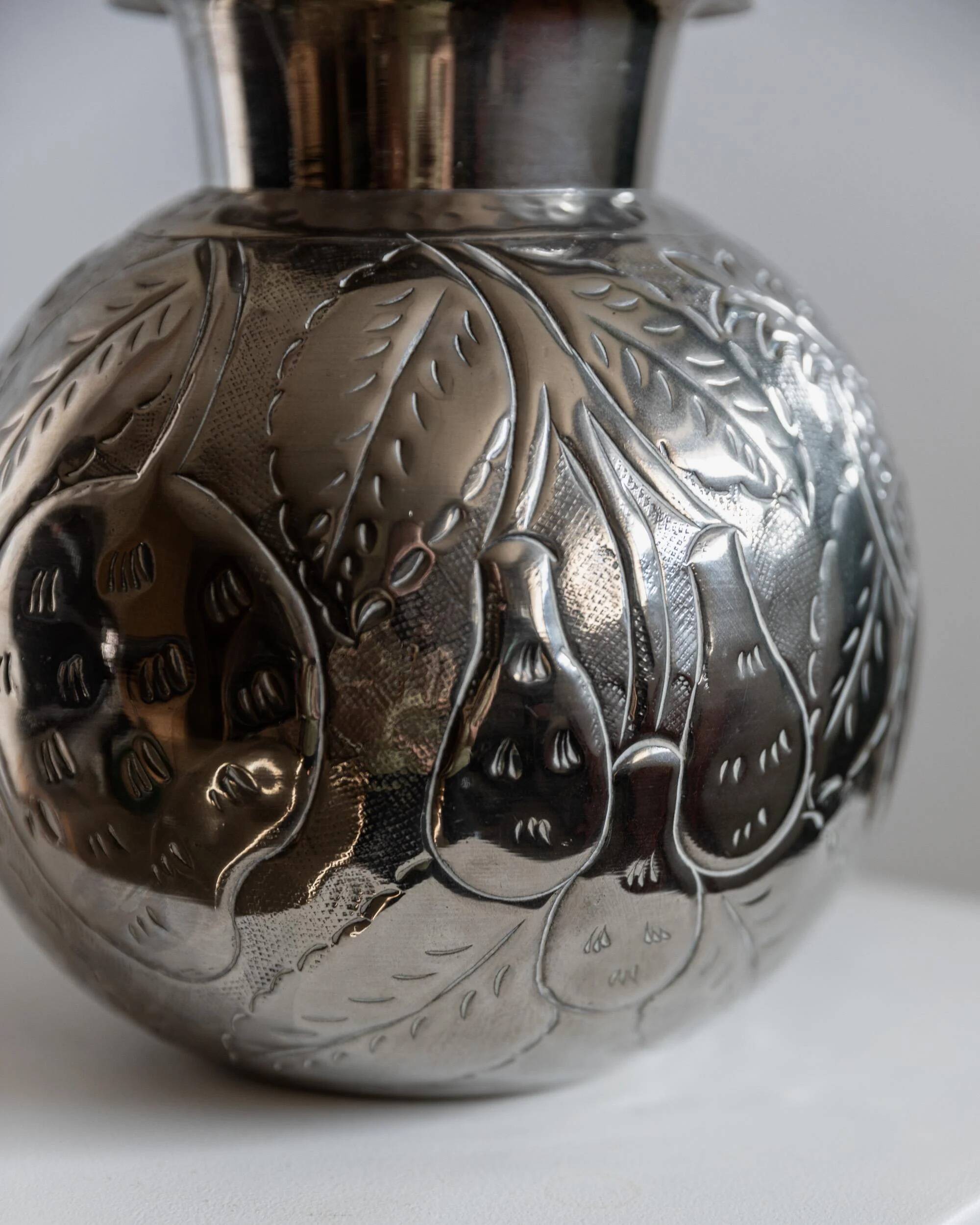 Vintage Italian vase in nickel-plated brass from the 1960s, hand-hammered relief of fruits and leaves.