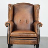 Large and comfortable sheepskin leather wingback chair with black piping