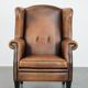 Large and comfortable sheepskin leather wingback chair with black piping