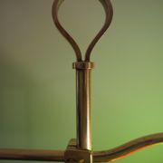 Desk lamp in brass with a swan neck and green opaline glass.