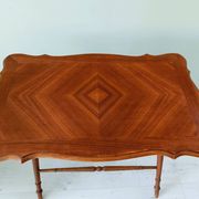 Vintage folding table with turned legs.