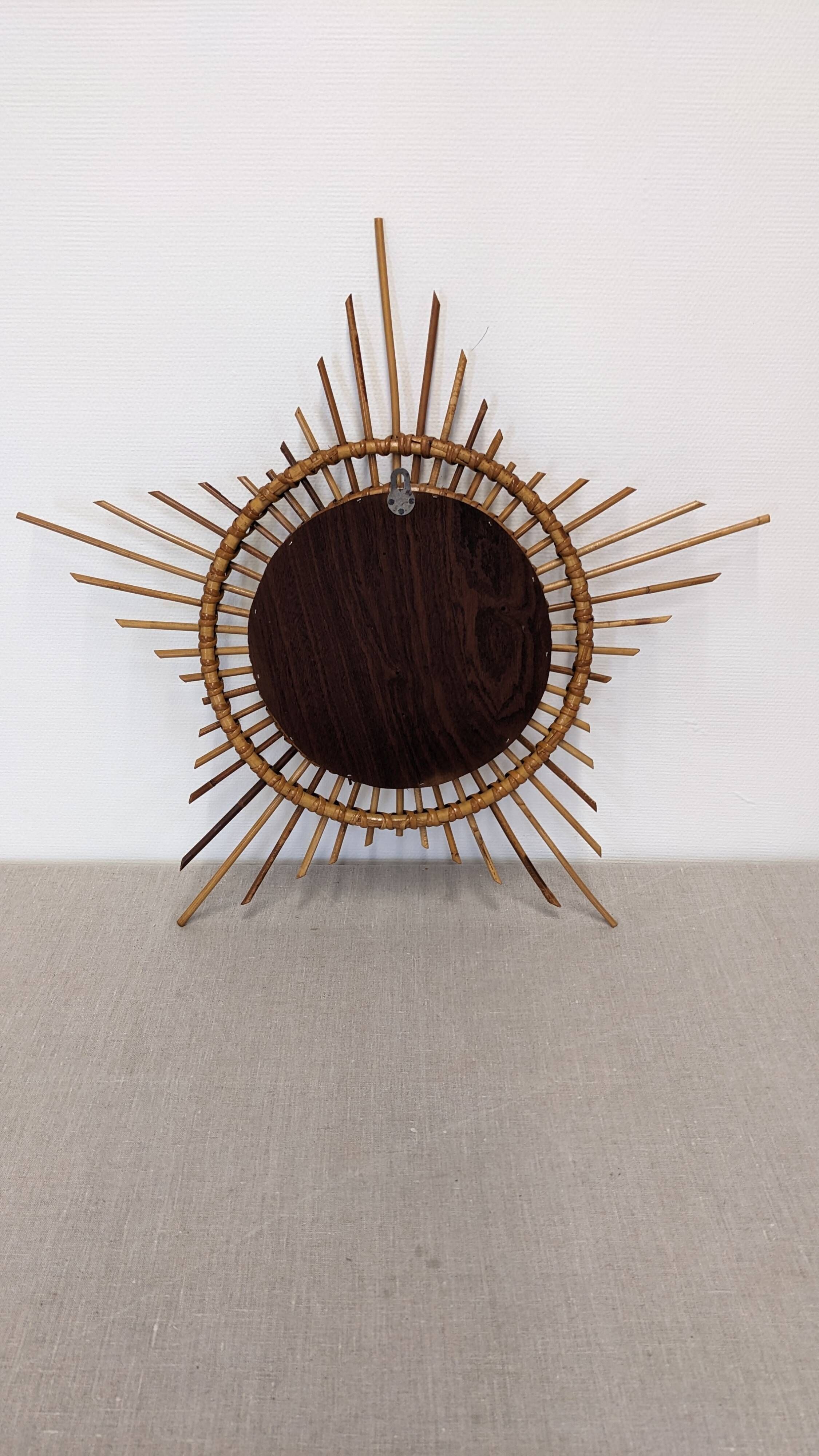 Starry sun mirror in rattan, France around 1960.